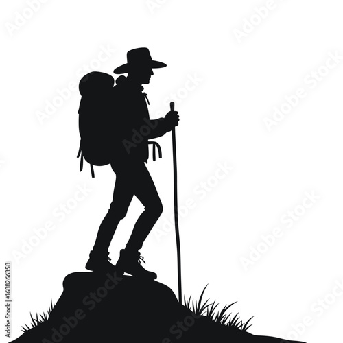 Black silhouette of a hiker with a backpack and trekking pole on a rock