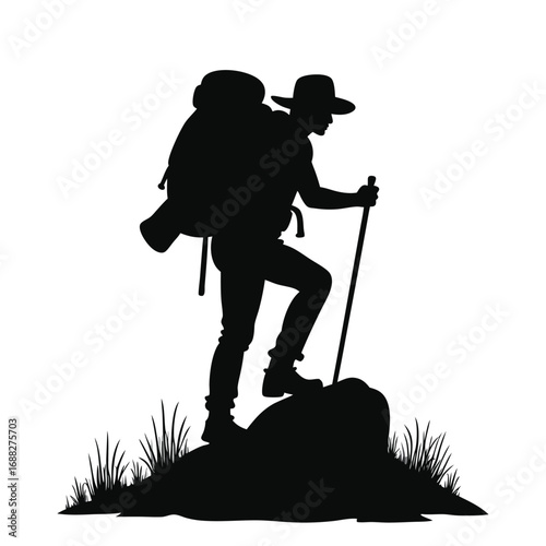Silhouette of hiker with backpack and trekking pole on rock 3