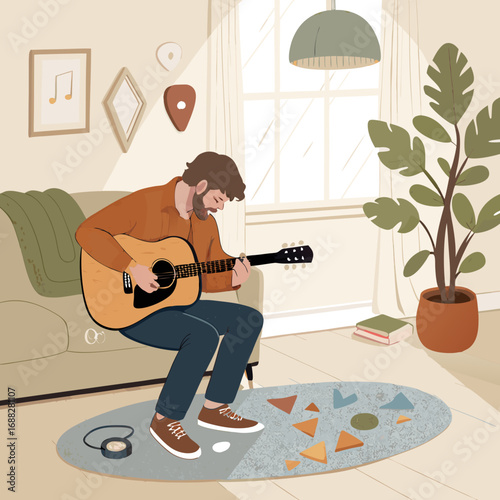 Man enjoying his hobby playing acoustic guitar at home.