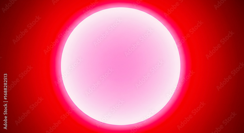 Obraz premium Abstract glowing red orb with a bright pink center on a solid red background, representing energy and light