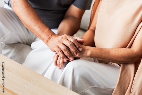 Billede på lærred Senior couple holding hands showing love, care, and emotional support
