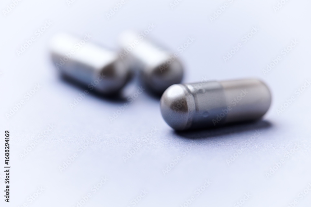 Fototapeta premium BCAA amino acids tablets. Nutrition for bodybuilding. Fitness supplements on bright background. Soft focus. Copy space. 