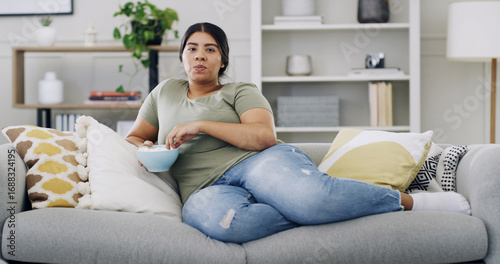 Εκτύπωση καμβά Woman, couch and relax with popcorn in home for portrait, streaming or movie binge on weekend