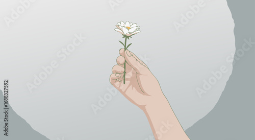 A delicate white flower is held gently in a person's hand against a soft grey background.