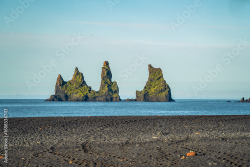 Black sand beach, church and city of Vik, Iceland