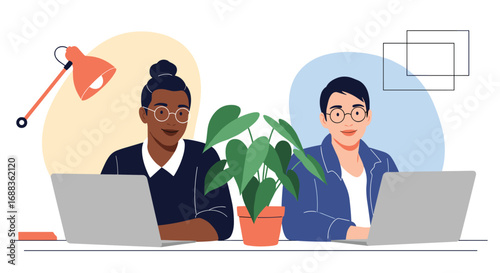 Two diverse individuals working together on laptops in a modern office environment