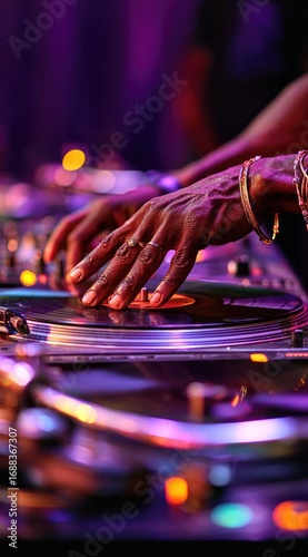 A DJ's hands, adorned with jewelry, mixing a vinyl record on a turntable, bathed in vibrant purple and blue lighting in a club atmosphere
