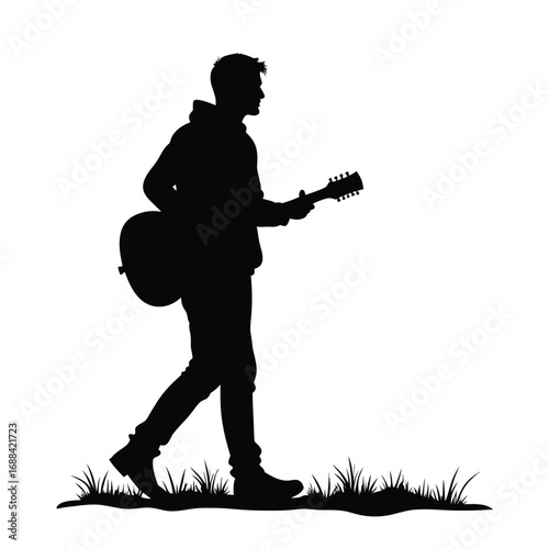 Black silhouette of a man walking with a guitar acoustic guitar