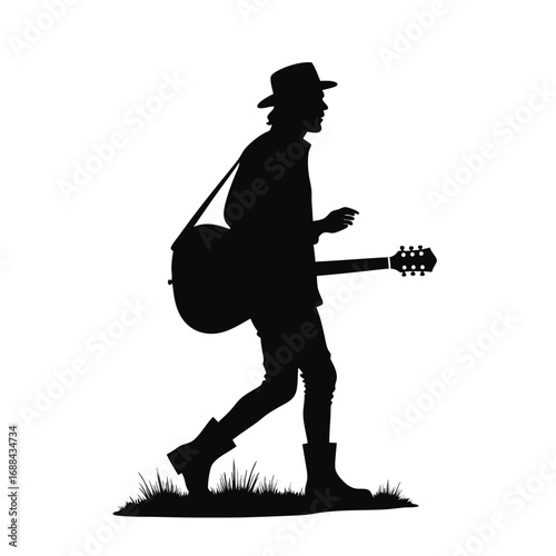 Silhouette of a man walking with a guitar acoustic guitar