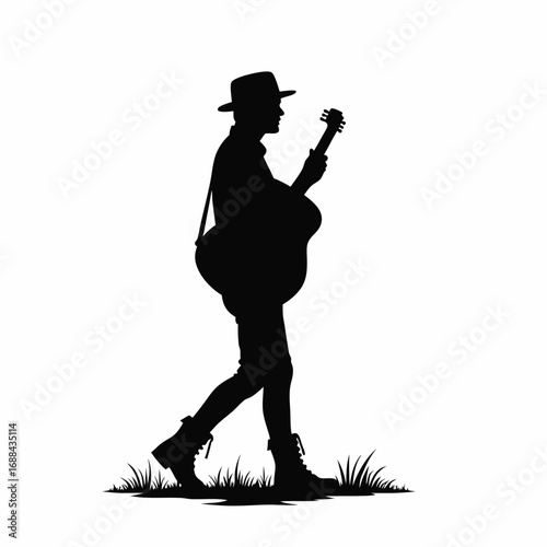 Silhouette of a man walking with a guitar and hat acoustic guitar