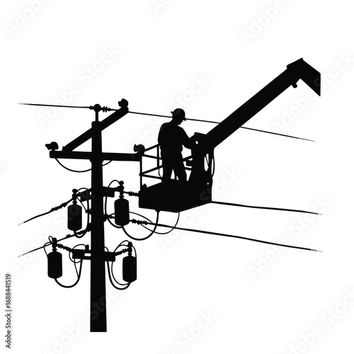 Silhouette of lineman working on power lines from bucket truck
