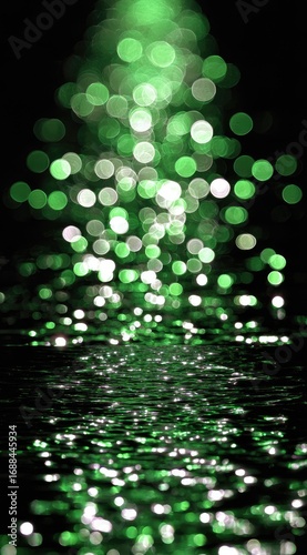 Glowing green orbs cascade towards a dark, reflective surface, creating a mesmerizing display of bokeh and shimmering highlights