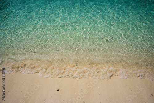 Clear ocean water in the sea with clean sand beach.
