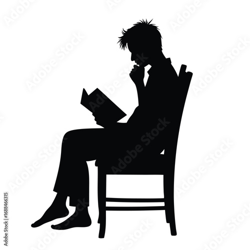 Silhouette of person sitting in chair reading a book