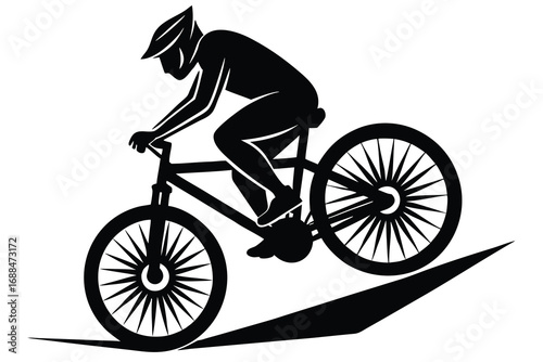 Black Silhouette of a Cyclist Riding a Mountain Bike on a Sloped Trail