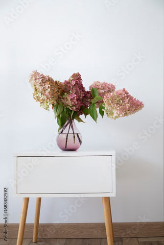bouquet of hydrangea in  vase in white room