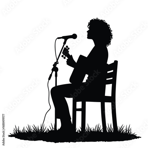 Silhouette of person playing guitar and singing into microphone outdoors 2