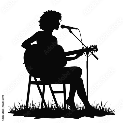 Silhouette of woman playing acoustic guitar and singing into microphone 1
