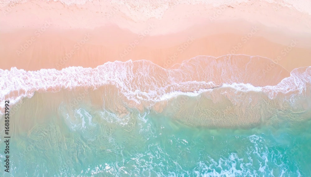 Fototapeta premium An aerial view captures the meeting of a sandy beach and turquoise ocean waves, creating a serene, abstract composition of light and color
