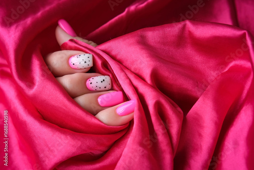 Manicure with a beautiful pink design on short square nails. Bright manicure
