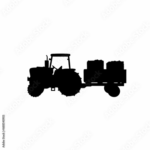 Silhouette of a tractor harvesting grapes in a vineyard