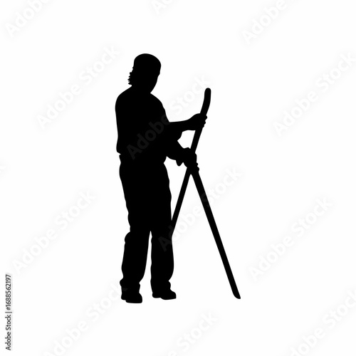 Silhouette of a worker sharpening grape harvesting shears