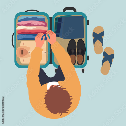 Traveler packing suitcase with clothes and shoes on light blue background. View from above