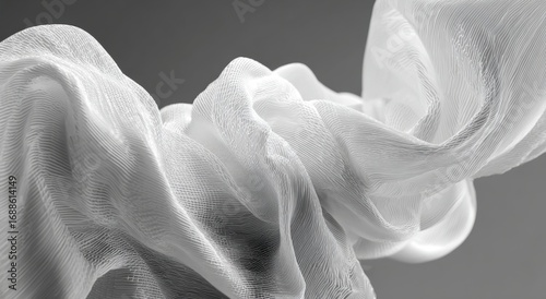 Flowing white fabric in motion.  Soft folds and textures.  Studio shot