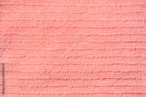 A horizontal close-up shot of a light pink microfiber cloth with a fluffy horizontal texture, serving as a clean and abstract background
