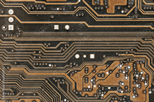 Macro macro photography of motherboard with copper tracks and soldering. Lots of connections and contact points. Abstract technical structure, Textalite and electronics parts.