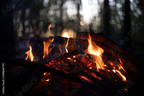 A bonfire at sunset. Flame against the sunset. Yellow flames of a bonfire.