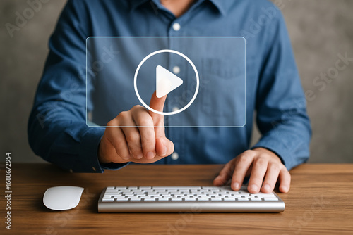 Man Pressing Virtual Play Button on Transparent Screen