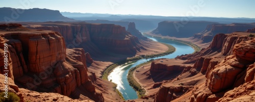 Wallpaper Mural expansive canyon gorge shaped by erosion, winding river reflecting cliffs, atmospheric sunlight casting shadows, cinematic panoramic wide shot rendered in ultra realistic desert landscape environment Torontodigital.ca