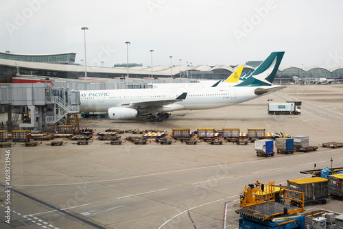 Exterior architecture buildings of Hongkong international airport and Aircraft boeing stop waiting passenger journey and local crew worker prepare plane on runway on April 26, 2025 in Hong Kong, China