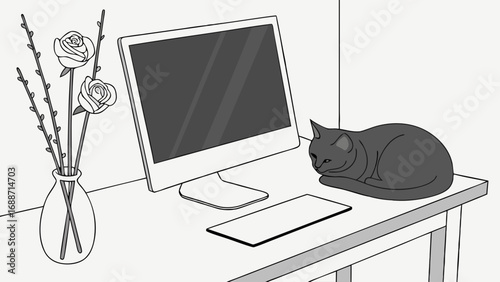 Relaxing cat at a home office desk with computer and flowers.
