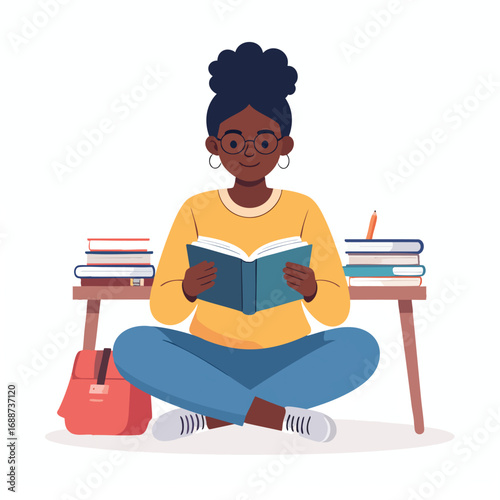 A young woman sits cross-legged, engrossed in reading a book with stacks of books nearby.