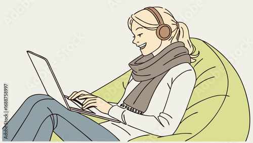 Woman working on laptop in comfy chair wearing headphones and scarf.