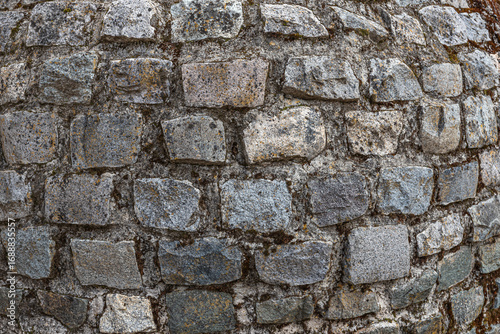 Closeup of Rustic Stone Wall with Irregular Textures and Weathered Appearance