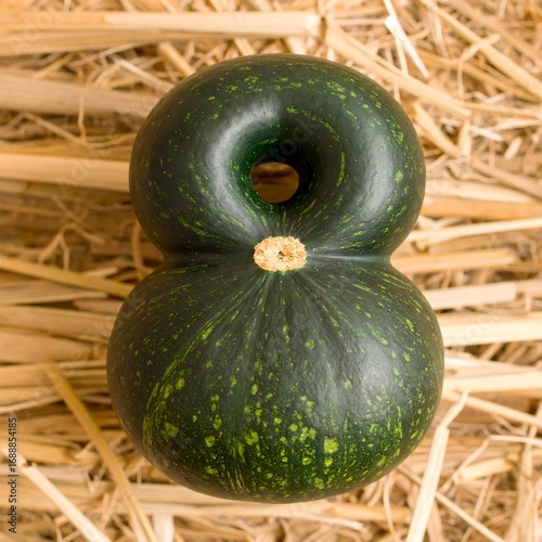 Green gourd shaped as number eight on straw