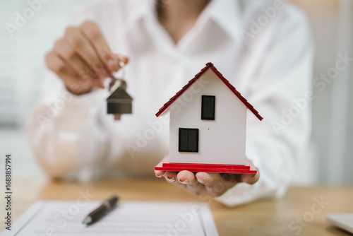 Wallpaper Mural A real estate agent hands over keys after signing a property contract, symbolizing investment, ownership, mortgage, financial success, and homeownership achievement. Torontodigital.ca