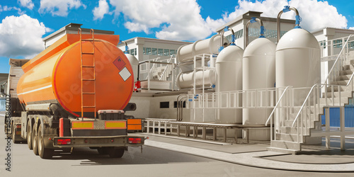 Bild auf Leinwand industrial facility with large storage tanks and pipelines, alongside an orange fuel tanker truck parked for loading or unloading