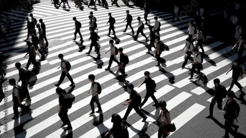 Wallpaper Mural People cross a zebra crossing in Tokyo, Japan. An abstract aerial view showing the flow of life. City life, urban landscape, transportation hub. Torontodigital.ca