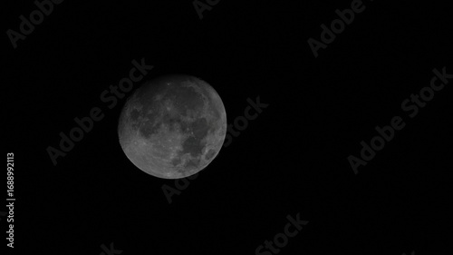 Earth’s Moon (Luna) captured in the night sky. A detailed monochrome view of lunar surface with visible craters and textures, symbolizing mystery and cosmic beauty