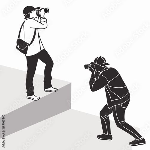 Two photographers capturing moments with their cameras one on stairs and one in a crouched position