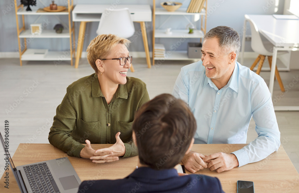 Fototapeta premium Happy senior couple visiting realtor, agent, discussing insurance agreement, real estate contract in office, adult elderly man, woman meeting with lawyer, solicitor, broker common deal, help, advice