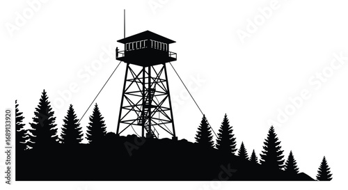 a lookout tower stands tall among pine trees on hill