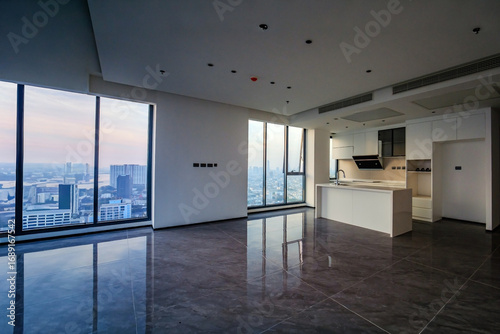 empty space of the kitchen of a condominium room with the view of the big city outside