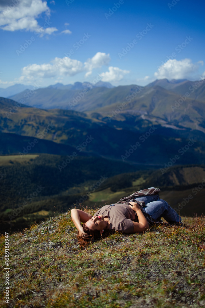 Fototapeta premium Happy woman enjoying freedom and fresh air on mountain top, relaxing in nature with scenic landscape view, travel and wellness lifestyle inspiration outdoors