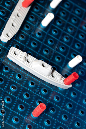 Photography Close up of strategic battleships board game with ships and pegs