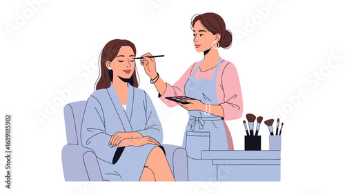 Professional makeup artist applying eyeshadow to a woman sitting comfortably in a chair wearing a robe